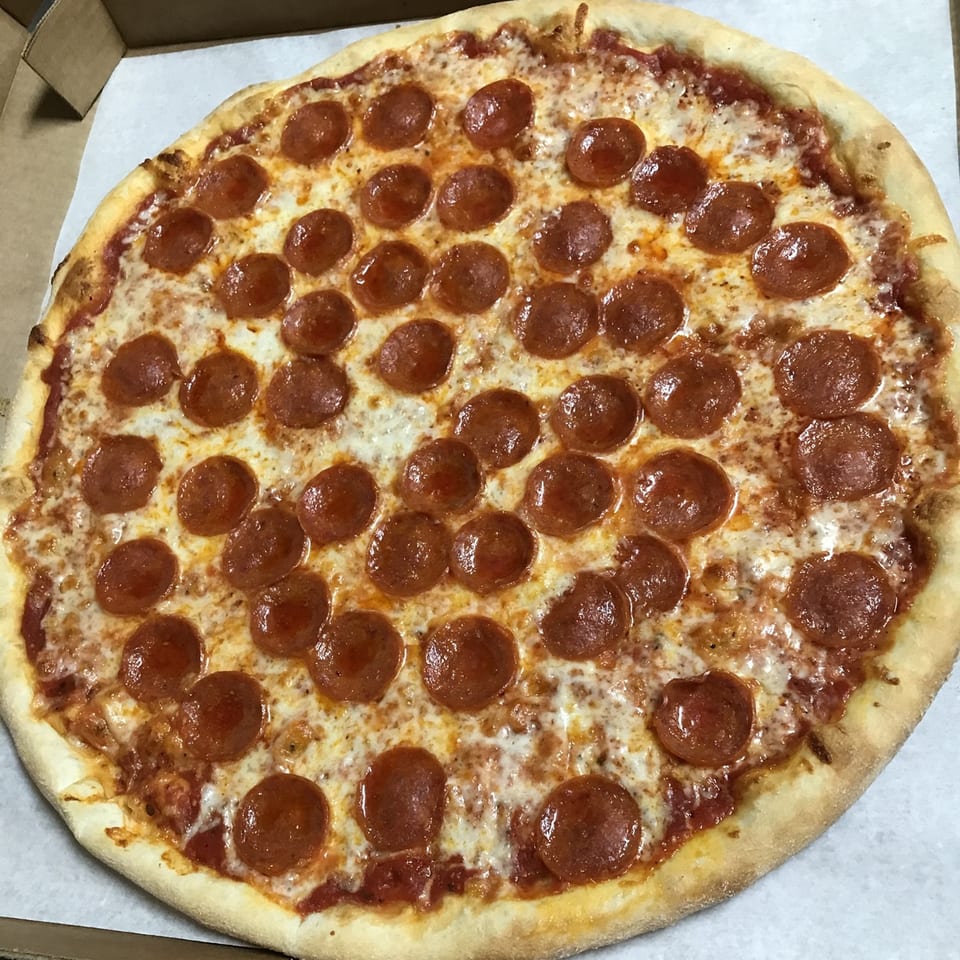 A whole pepperoni pizza from Napoli's Pizzeria, with melted cheese and a crispy crust in a box.