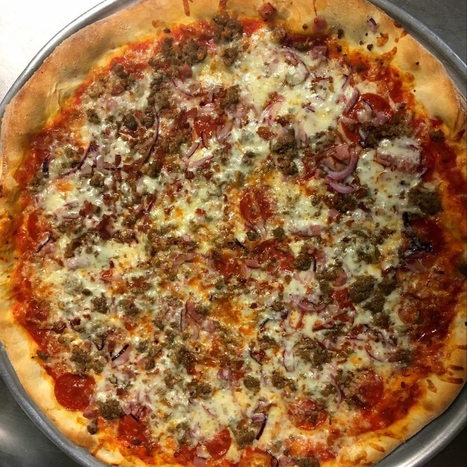 Napoli's Pizzeria's meat lover's pizza, topped with pepperoni, sausage, and red onions.